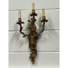 a wall light with two candles attached to it