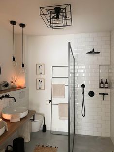 a bathroom with white tiles and black fixtures