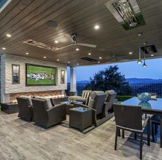 an outdoor living room with large couches and tables