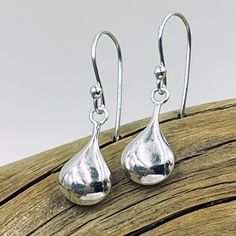 Delicate sterling silver puffed teardrop shines from sterling silver earring wires. Teardrop measures approximately 16mm x 8mm Silver Pear-shaped Earrings With Polished Finish, Formal Sterling Silver Teardrop Earrings With Polished Finish, Formal Sterling Silver Teardrop Earrings, Sterling Silver Long Drop Earrings, Silver Teardrop Earrings With Polished Finish, Silver Sterling Teardrop Earrings With Polished Finish, Silver Teardrop Earrings With Polished Finish For Gift, Sterling Silver Drop Earrings For Everyday, Classic Teardrop Drop With Polished Finish