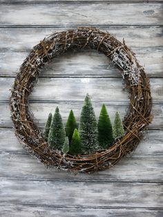 a wreath with small trees on top of it