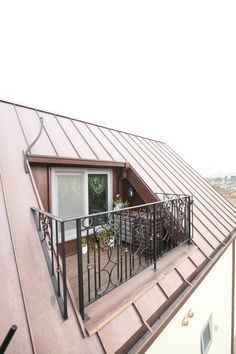 a balcony with metal railings and an open door