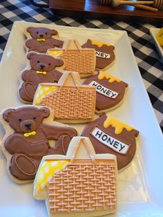 some cookies are on a white plate and have teddy bears in the shape of waffles