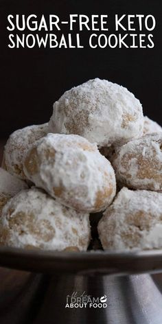 sugar - free keto snowball cookies stacked on top of each other in a bowl