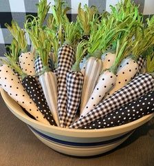 a bowl filled with napkins and vegetables on top of a table