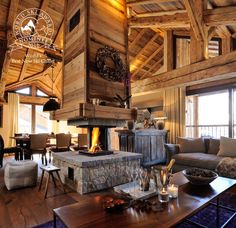 a living room filled with furniture and a fire place in the middle of a room