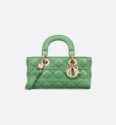 The Lady D-Joy bag captures the House's vision of elegance and beauty by showcasing the iconic streamlined aesthetic of the Lady Dior line. Crafted in jade green lambskin with Cannage stitching, the refined and timeless style is enhanced by pale gold-finish metal D.I.O.R. charms illuminating its silhouette. Featuring one detachable chain strap and another adjustable and removable leather strap, the small Lady D-Joy bag can be carried by hand, worn over the shoulder or crossbody as a daily compan Designer Green Bag With Leather Lining, Luxury Green Bag With Leather Lining, Luxury Green Bags, Formal Green Bags With Leather Lining, Green Leather Bag For Everyday Luxury, Ethereal Green, Lady D Joy Bag, Lady D, Verde Jade