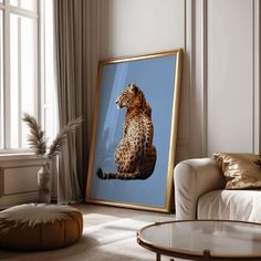 a framed photograph of a cheetah sitting on its hind legs in a living room