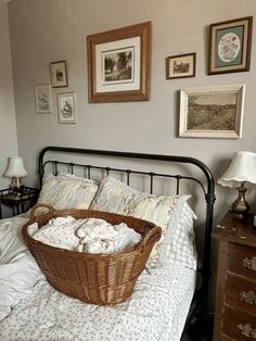 a wicker basket sitting on top of a bed