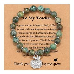 a bracelet with an apple charm on it that says, to my teacher the great teacher is