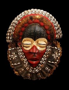 an african mask is shown against a black background