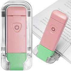 a pink and green device sitting on top of a laptop