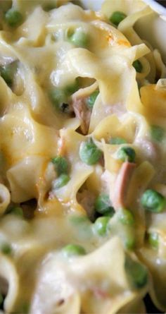 a bowl filled with pasta and peas on top of a table