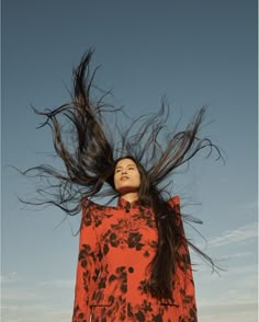 a woman with her hair flying in the air