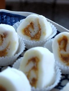 some kind of dessert with peanut butter on top in a blue and white plate next to other food items