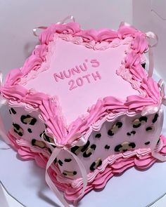 a pink and black cake with leopard print on it