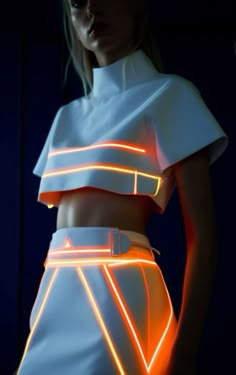 a woman in white dress with neon lights on her chest and skirt over her body