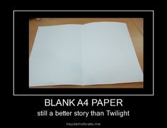 an open book sitting on top of a wooden table next to a white sheet of paper