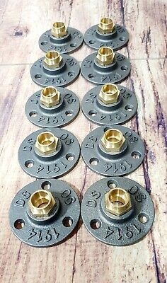 eight cast iron wheel hubs with brass fittings on each one side and two holes in the middle