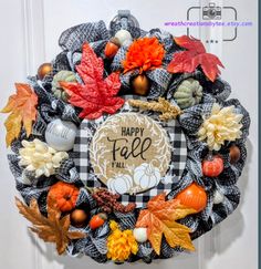 a happy fall wreath hanging on the front door