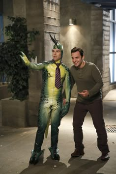 two men in costumes standing next to each other