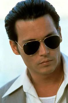 a man wearing sunglasses and a white shirt