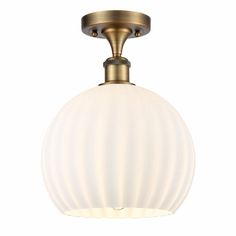 a light fixture with a white glass ball on the bottom and an antique brass finish