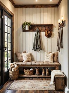 an entryway with a bench and coat rack