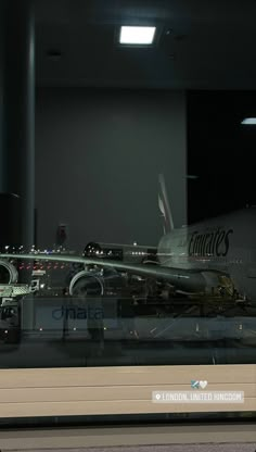 an airplane is on display in a glass case with the name anata written on it