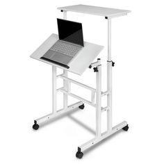 a computer desk with a laptop on it