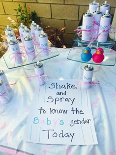 a table topped with lots of baby's genderal products and bottles filled with water