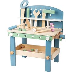 a child's wooden workbench with tools on the top and bottom shelf