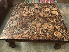 a wooden table with intricate designs on it