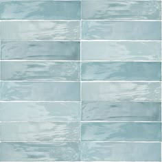 a blue tile wall that has been painted in shades of gray and light blue with white stripes