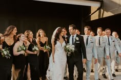 a group of people that are standing in front of each other wearing suits and ties