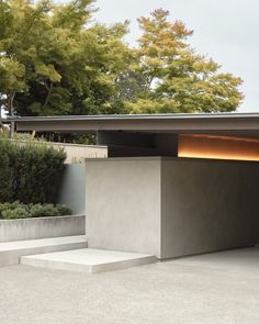 an open garage with steps leading up to it and trees in the backgroud