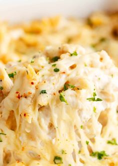 a close up view of a casserole dish with chicken and cheese on it