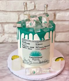 a cake made to look like a bottle of alcohol with ice and limes on top