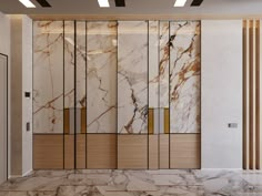 an empty room with marble walls and flooring in the center, along with two elevators