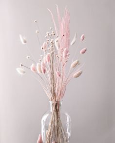 a vase filled with pink flowers on top of a table