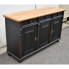 an old black buffet with wood top