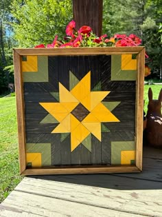 a wooden box with flowers in it sitting on a deck next to a bunny rabbit