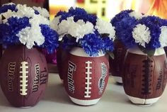 three football vases with flowers in them