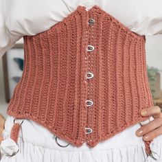 a woman wearing a corset with buttons on it