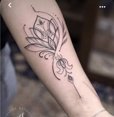 a woman's arm with a flower tattoo on it