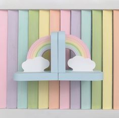 a shelf with two rainbows and clouds on it