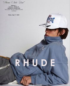 a man wearing a white hat and blue jacket with the words rhude on it