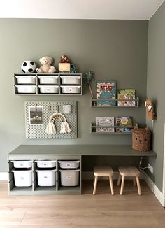 a child's playroom with toys and storage bins on the wall above