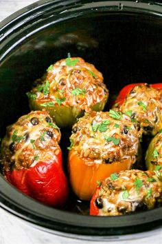 several stuffed peppers in a slow cooker