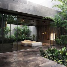 the interior of a modern house with large glass doors and plants in the foreground